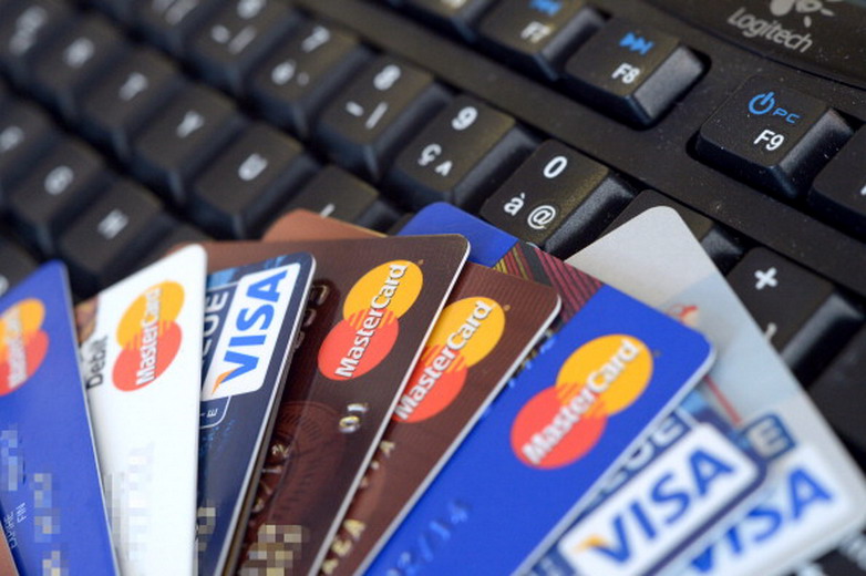 Credit cards are pictured on a computer's keyboard on February 5, 2013  in Rennes, western France. French police has arrested, early this morning in Paris and in several French and overseas departments, 22 people in connection with the trade of credit cards numbers on internet.  AFP PHOTO DAMIEN MEYER        (Photo credit should read DAMIEN MEYER/AFP/Getty Images)